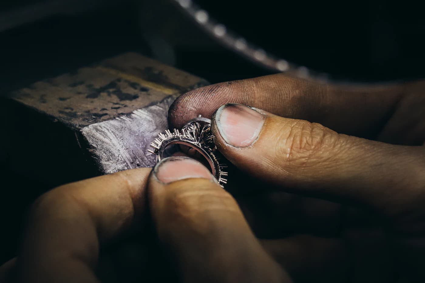 A jeweller setting a ring by hand