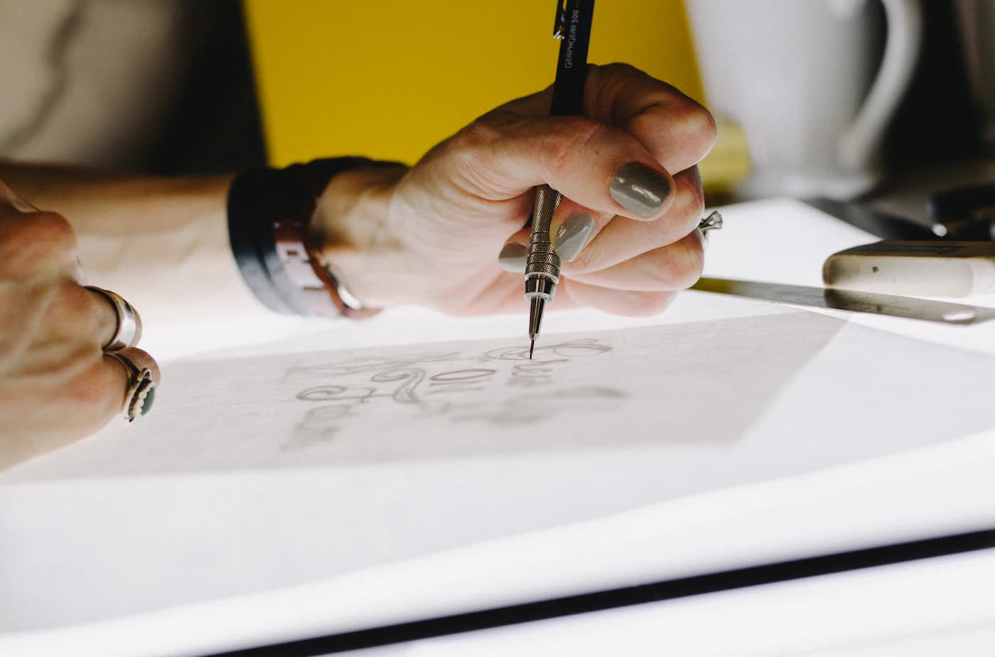 A jewellery design being sketched by hand